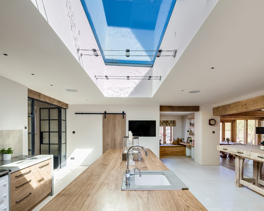 Modern traditional kitchen with a frameless glass rooflight set into the ceiling