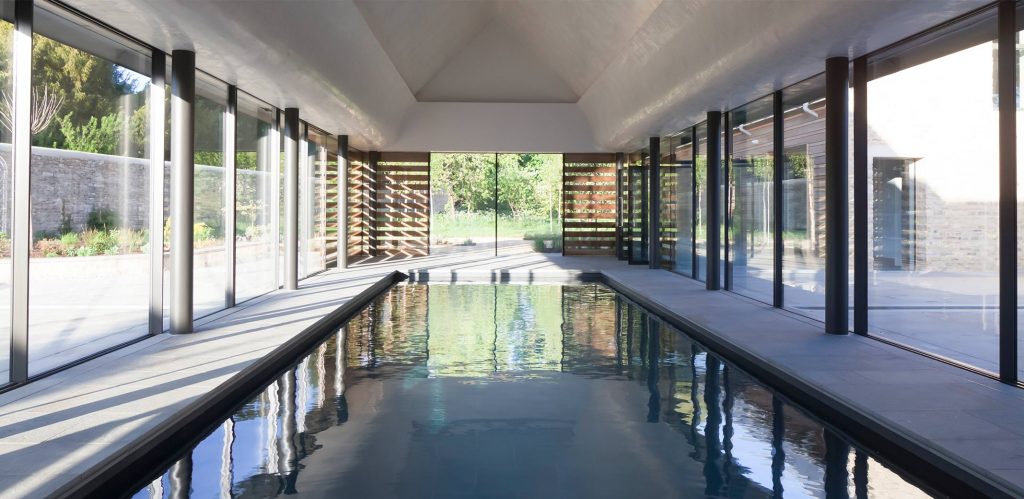 Pool house with glass walls and external glass sliding doors
