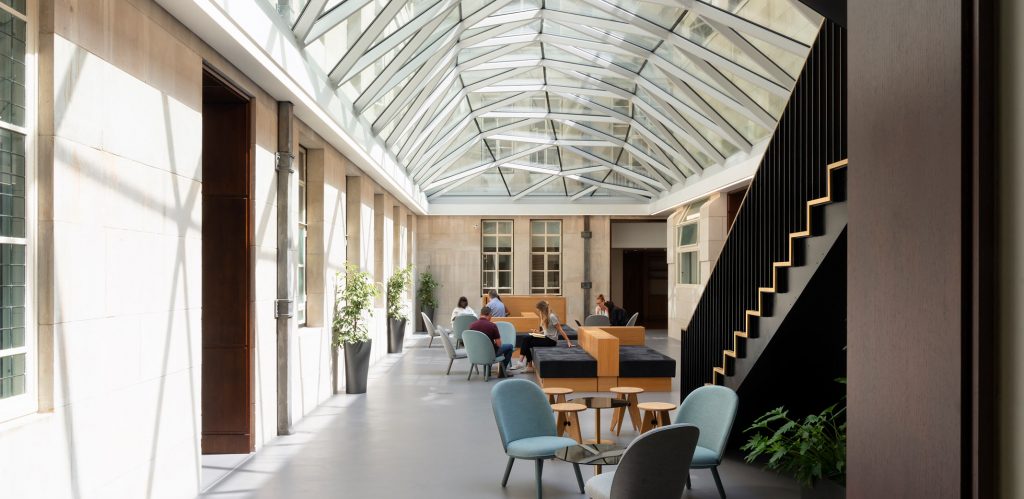 Open-plan working space under a glass atrium roof