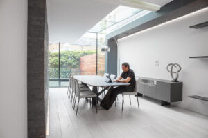 Man working in an airy. light home office 