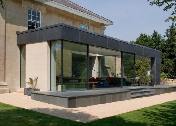 Glazed box extension on the rear of a limestone country house