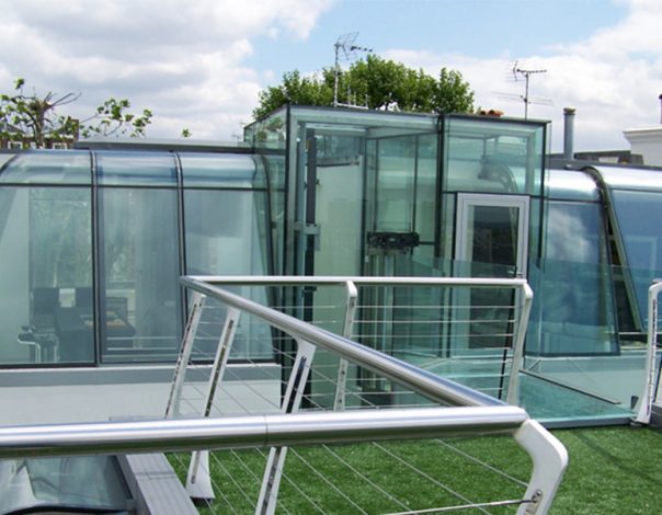 Curved glass pod on the roof of an urban house