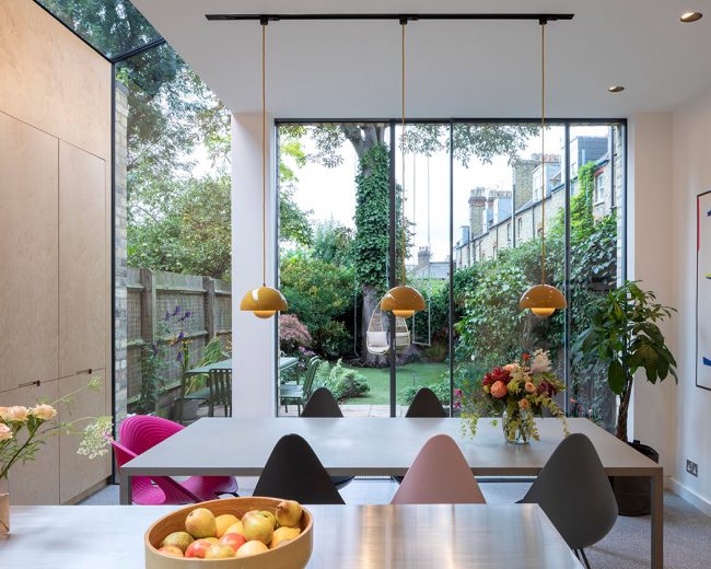 Bright, modern kitchen with Sky-Frame sliding doors looking out onto a small urban garden