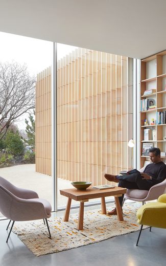 Man sitting in a cosy living room space with Sky-Frame sliding doors