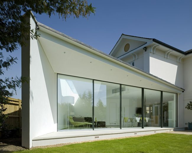 Modern, angular white-rendered rear extension with Sky-Frame external glass sliding doors