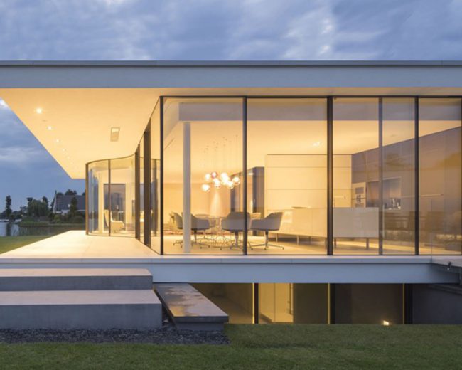 Large modern home with curved glass architecture