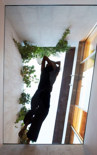 Woman reclining on a glass floor viewed from below