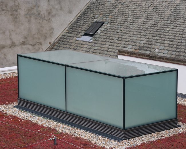 Green roof with a frameless glass box incorporating opaque switchable glass panels